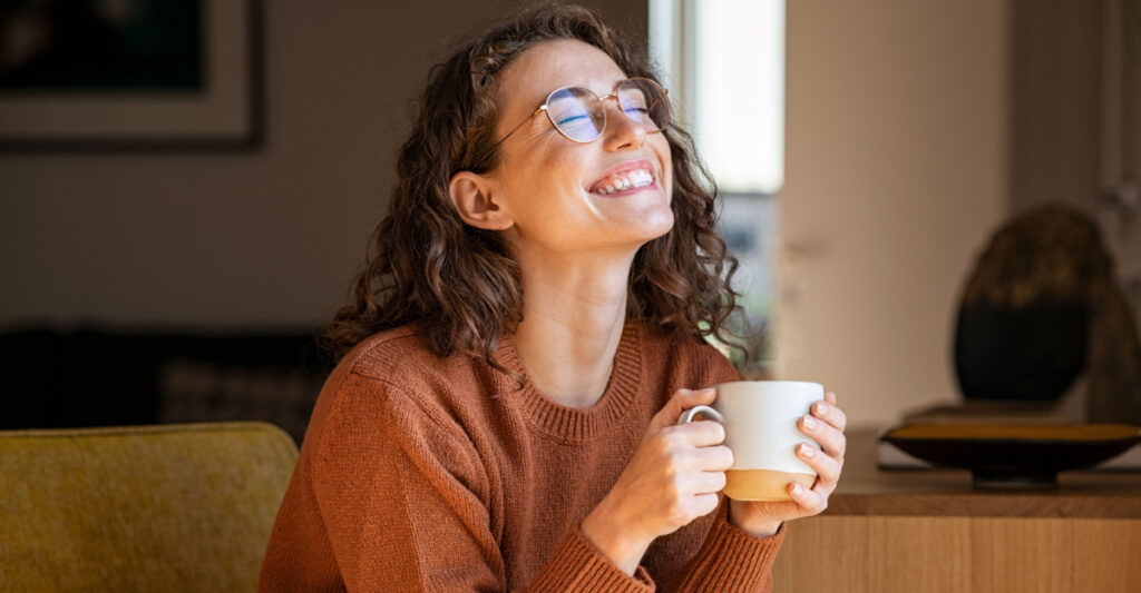 A Smiling Woman Holding a Cup