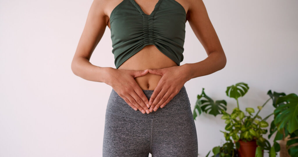 Woman keeping her hands on her belly