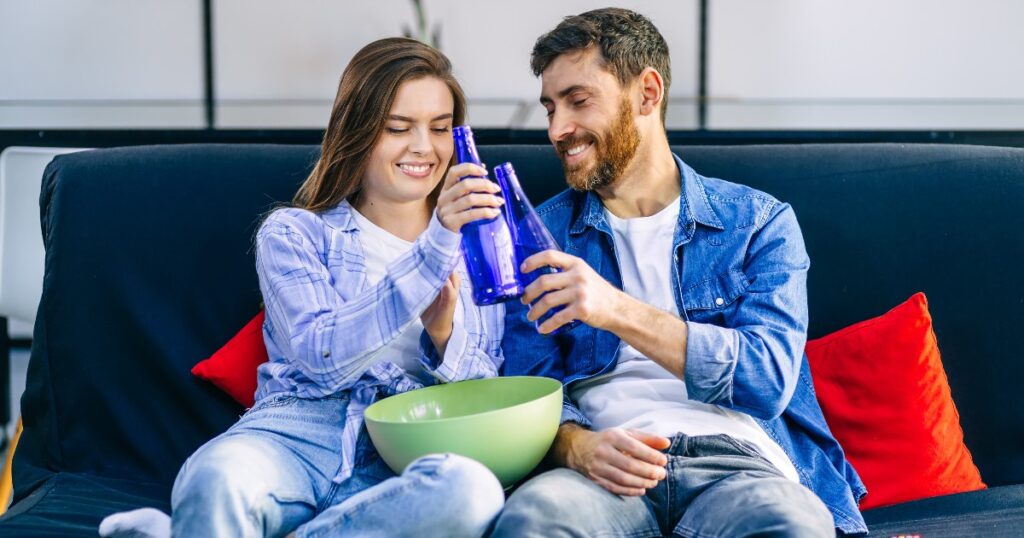 A happy couple sitting on the couch