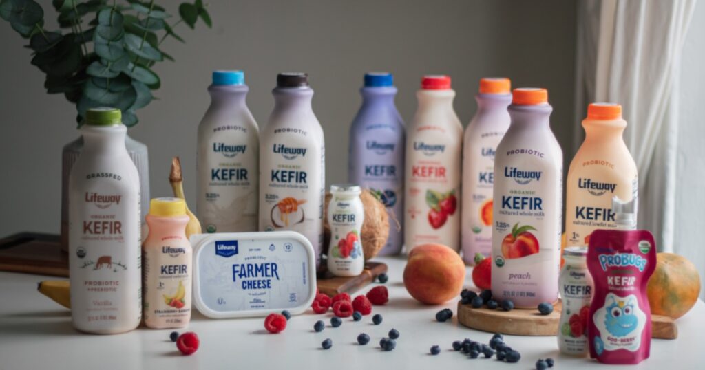 Assorted Lifeway Kefir bottles and fresh ingredients for making gut-friendly drinks.
