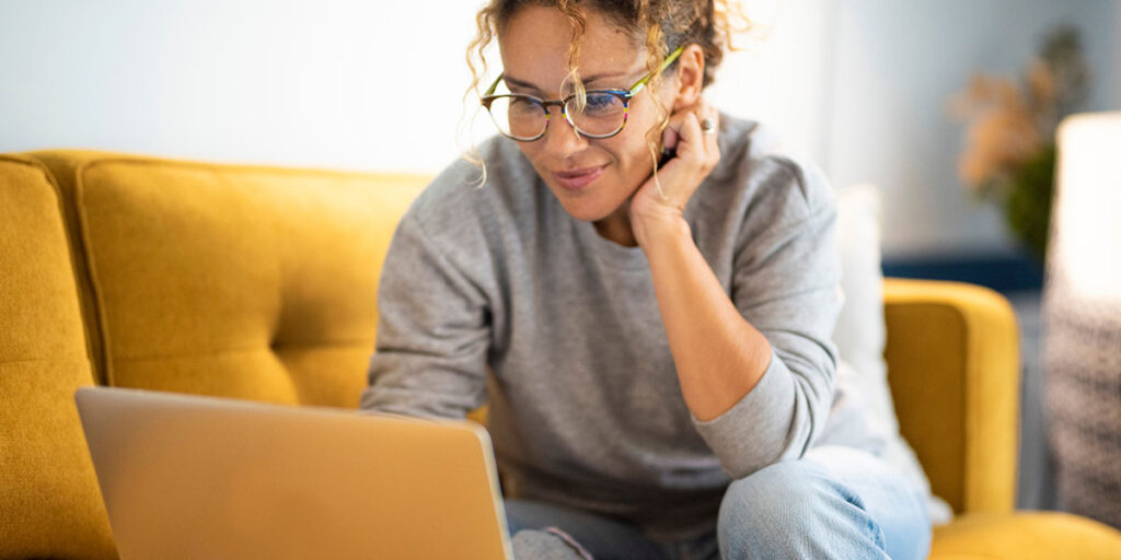 A woman uses her laptop to search for information.